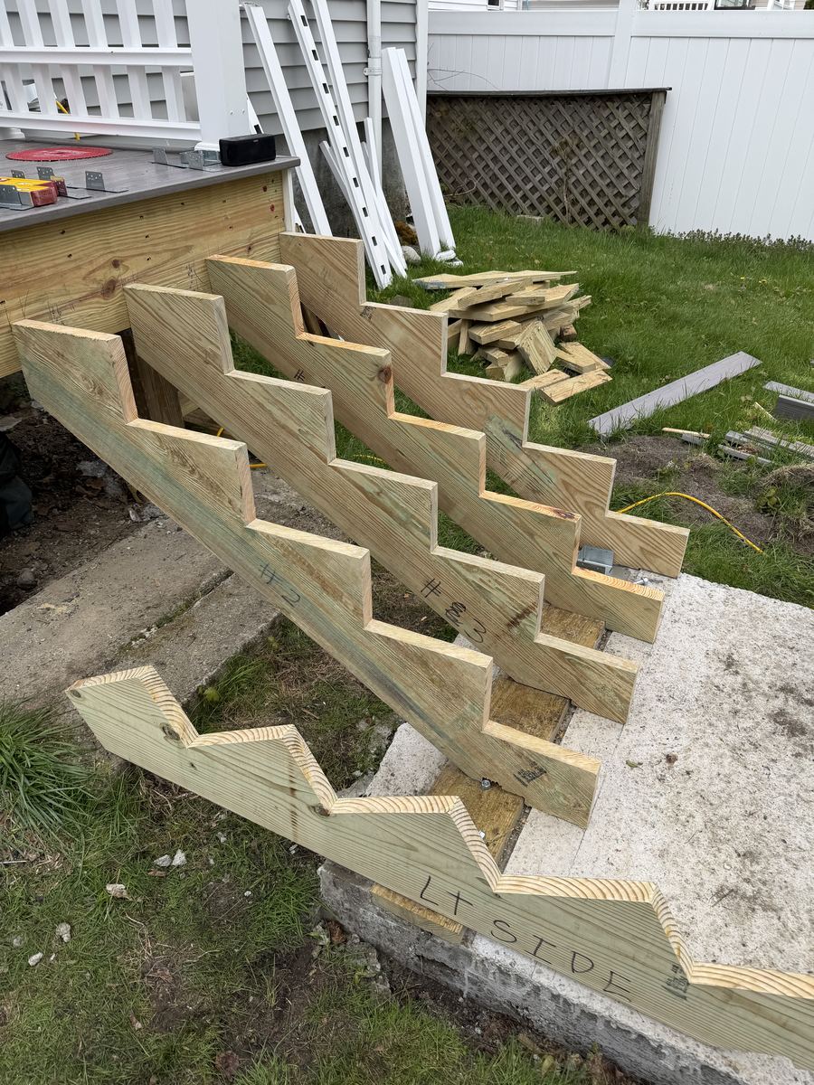 New pressure-treated stringers and treads on a common stair