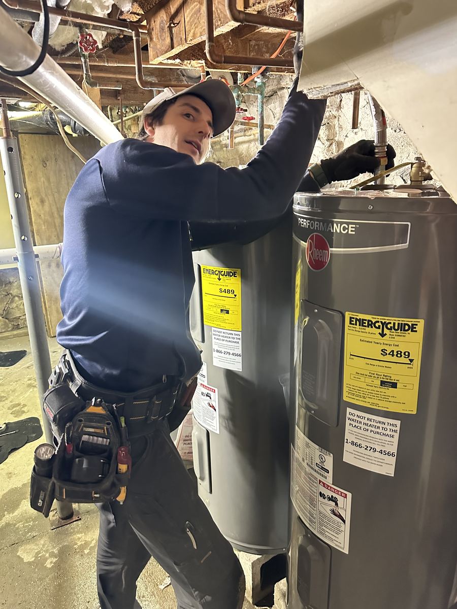 Partner on site during a water heater replacement in a basement